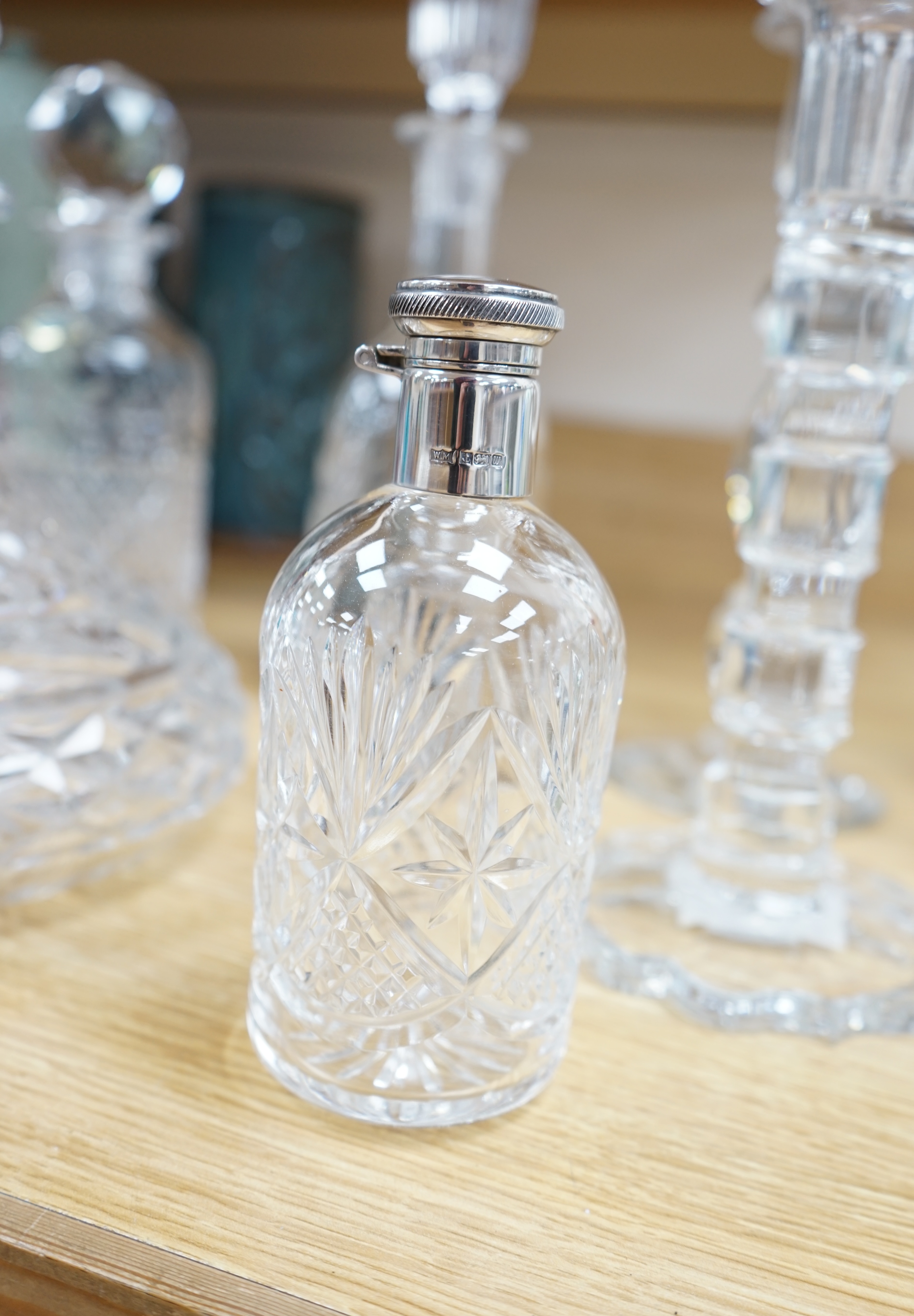 A cut glass ship’s decanter, two others and three various cut glass candle sticks, tallest decanter 30cm high. Condition - good